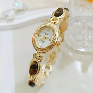 Elegant vintage style women's quartz watch with tiger eye stone and gold bracelet band.