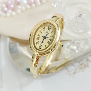 Vintage gold oval bangle watch for women with Roman numerals and quartz movement elegant.