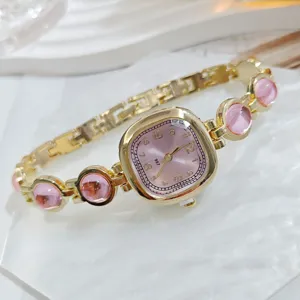 Reloj de mujer de oro elegante con esfera rosa y pulsera de piedras preciosas estilo