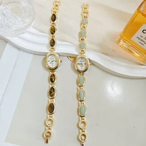Vintage gold-tone quartz watch with tiger eye and green stone gemstone bracelet for women.