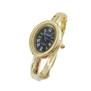 Vintage gold oval bangle watch for women with roman numerals black dial quartz movement chic.