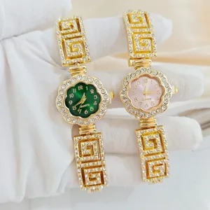 Luxurious rhinestone women quartz watch with elegant floral dial and chic gold Greek key strap.