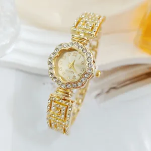 Gold rhinestone flower quartz watch detail, sparkling crystal dial and geometric strap.