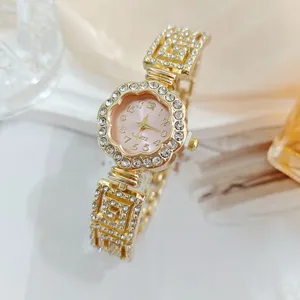 Details of luxury rhinestone flower women watch, gold quartz wristwatch with sparkling crystals.