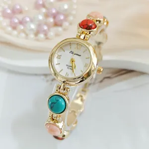 Elegante Damen Quarz Armbanduhr mit bunten Edelsteinen und edlem goldenem Design.