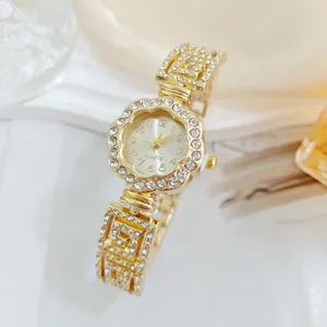 Luxury gold rhinestone floral women quartz watch detail view, elegant shiny crystal wristwatch bracelet