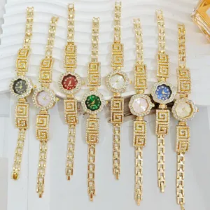 Elegant rhinestone flower dial quartz watches for women with luxury gold geometric link bracelets.