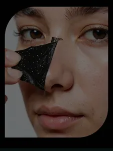 Detailed view showing bamboo charcoal blackhead peel-off nose strip being removed from skin.
