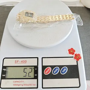 Close-up detail shot of the luxury full rhinestone square quartz watch displayed on scale.