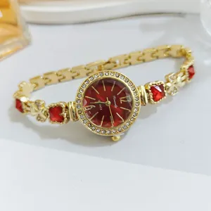 Close-up of the red dial quartz women's watch with clover chain links and sparkling rhinestones.