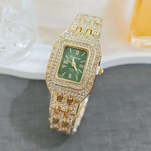 Detailed view of luxury gold rhinestone quartz watch with green dial and paved crystal band.