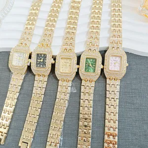 Detailed view of luxury square rhinestone quartz watches featuring gold metallic straps.