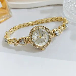 Elegant clover rhinestone women quartz watch with gold bracelet band and luxury dial details.