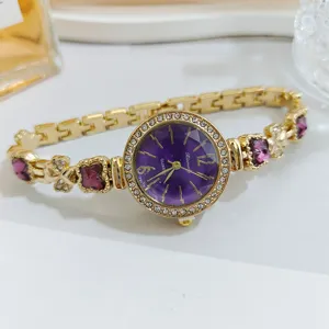 Luxury purple dial women watch with sparkling crystals, elegant clover bracelet design.