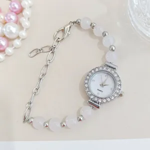 Women quartz watch with pink crystal beads and shiny rhinestones dial flatlay view