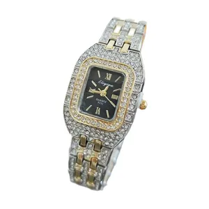 Square rhinestone studded quartz watch detail view, elegant two-tone metal wrist watch.