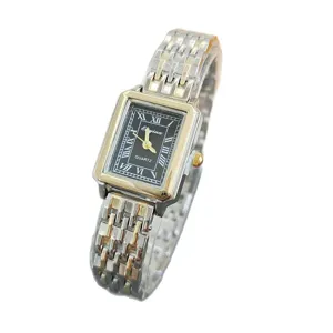 Detailed view of women's vintage square quartz watch with black dial and two-tone metal band.