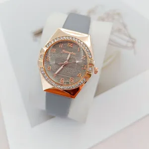 Elegant women quartz watch with grey strap rose gold rhinestone bezel and textured dial.