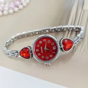 Women quartz watch with red heart crystal charm, silver stainless steel strap analog dial.