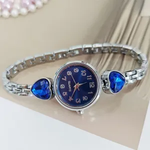 Women quartz watch with blue dial, silver metal bracelet and blue heart rhinestone accents.