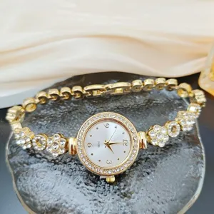 Elegant gold quartz watch for women with rhinestone bezel and floral bracelet links.