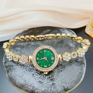 Luxurious gold quartz watch with green dial, sparkling rhinestones, floral bracelet design.