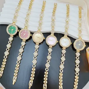 Luxury rhinestone flower ladies quartz watch with multi-color dial and crystal bracelet.