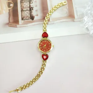 Chic gold-tone women quartz watch featuring red heart crystals and elegant link bracelet.