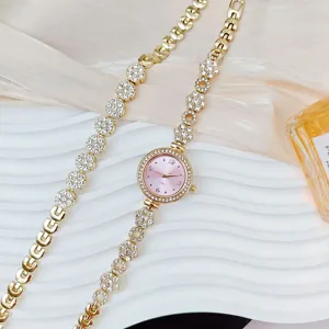 Luxury rhinestone floral women quartz watch and bracelet set detail view, elegant gold finish.