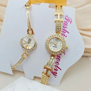 Luxus Damen Quarz Uhr und Armband Set in Gold mit Strasssteinen und Kleeblatt.