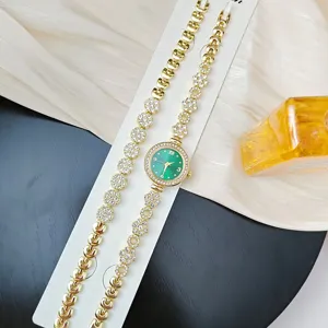 Women's luxury rhinestone quartz watch and bracelet set with green dial and elegant floral links.