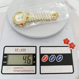 Gold rhinestone womens quartz watch detail view showing elegant sparkling metal band design.