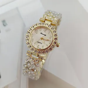Women's gold quartz watch, rhinestone bezel detail, elegant daily wear wristwatch accessory.