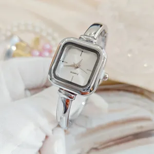 Gedetailleerd close-up van een stijlvol vierkant quartz horloge met armband en zilveren afwerking.