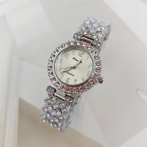 Luxury rhinestone women quartz watch with sparkling crystals and arabic numeral dial.