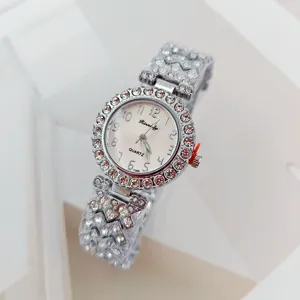 Luxury silver rhinestone quartz women's watch with shimmering crystal bezel and clear dial.
