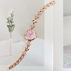 Elegante roségoldene Damen Quarzuhr mit Strass Blumen Gliedern und rosa Zifferblatt.