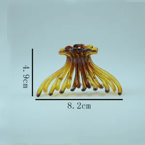 Amber plastic hair claw clip with dimension details, stylish and elegant hair accessory for women.