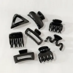 Detailed shot showing a variety of assorted black hair claw clips for styling details.