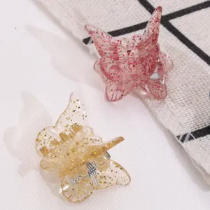 Cute mini butterfly hair claws in pink and gold with glitter, perfect for sweet daily styling.
