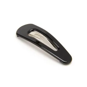 Close-up detail shot of a sleek black snap hair clip, showcasing the smooth glossy finish.