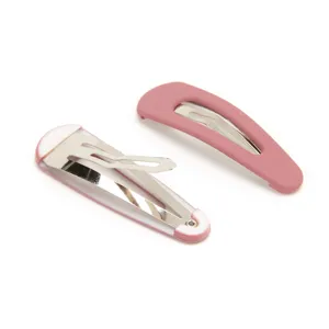 Detailed view of minimalist pink snap hair clips, showing front and back structure clearly.