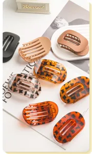 Detailed view of fashionable oval plastic hair claw clips set in multi-colors and tortoise shell.