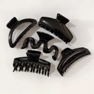 Black plastic hair claw clips set, various chic shapes for elegant daily styling detail view.