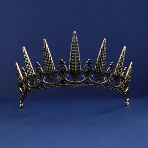 Detailed close-up of a vintage gold-plated crown headband embellished with black rhinestones.