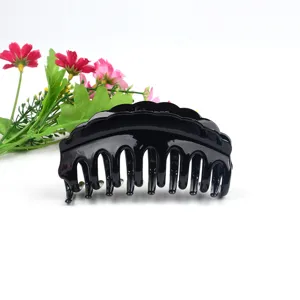 Large black plastic hair claw clip, classic minimalist styling accessory for daily wear.