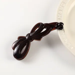 Fashionable brown jelly bow banana hair clip for women, elegant ponytail holder and accessory.