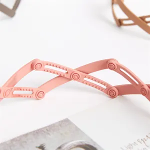 Minimalist pink telescopic headband with flexible cross design for daily fashion and stylish hair styling.