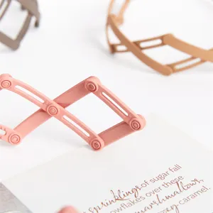 Minimalist telescopic hair clip detail shot, folding bird nest hairpin for daily styling.