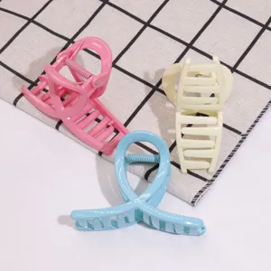 Minimalist plastic hair claw clip detail shot, multi-color fashion hair accessory for daily use.